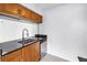 Galley kitchen featuring granite countertops, stainless steel appliances, and light wood cabinetry at 3300 Haviland Ct # 103, Palm Harbor, FL 34684