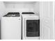 Laundry room with white washer and dryer at 3300 Haviland Ct # 103, Palm Harbor, FL 34684