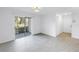 Inviting living room features tile floors, sliding doors to a balcony, and a convenient closet at 3300 Haviland Ct # 103, Palm Harbor, FL 34684