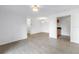 Spacious living room with wood-look tile flooring and neutral walls, offering a versatile living space at 3300 Haviland Ct # 103, Palm Harbor, FL 34684