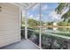 Enjoy serene lake views from this screened porch with lush greenery and abundant nature at 3300 Haviland Ct # 103, Palm Harbor, FL 34684
