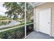 Enjoy serene lake views from this screened porch with lush greenery at 3300 Haviland Ct # 103, Palm Harbor, FL 34684