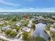 An aerial view showing the community with a lake and lush landscaping at 3305 Haviland Ct # 101, Palm Harbor, FL 34684