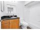 Bathroom with wood vanity, granite countertop, framed mirror, and a shower-tub combo at 3305 Haviland Ct # 101, Palm Harbor, FL 34684