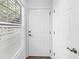 Bright entryway with white door and closet, and wood-look floors at 3305 Haviland Ct # 101, Palm Harbor, FL 34684
