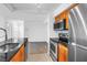 Open kitchen with granite counters and stainless appliances leading to living area at 3305 Haviland Ct # 101, Palm Harbor, FL 34684
