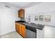 Modern kitchen with black granite counters and stainless steel dishwasher at 3305 Haviland Ct # 101, Palm Harbor, FL 34684
