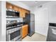 Updated kitchen featuring stainless steel appliances and modern cabinetry at 3305 Haviland Ct # 101, Palm Harbor, FL 34684