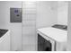 Bright laundry area featuring modern appliances and convenient wall-mounted storage racks and utility panel at 3305 Haviland Ct # 101, Palm Harbor, FL 34684