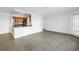 Open-concept living space with wood-look floors, an open kitchen bar, and a glass-paneled entry door at 3305 Haviland Ct # 101, Palm Harbor, FL 34684