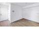 Bright, vacant living room with wood-look floors and white walls at 3305 Haviland Ct # 101, Palm Harbor, FL 34684