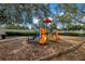 The community playground featuring colorful slides, climbers, and mulch ground cover at 3305 Haviland Ct # 101, Palm Harbor, FL 34684
