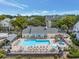 Aerial shot featuring a community pool, sun loungers, pergola and mature landscaping at 3305 Haviland Ct # 101, Palm Harbor, FL 34684