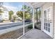 View of parking lot from screened-in porch, with an exterior door and white trim at 3305 Haviland Ct # 101, Palm Harbor, FL 34684