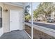 View of parking lot from screened in porch with beige siding and white trim at 3305 Haviland Ct # 101, Palm Harbor, FL 34684
