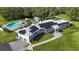 Stunning home featuring solar panels, a pool, well manicured lawn, and an outdoor entertaining area at 3425 W Forest Lake Cir, Sarasota, FL 34232