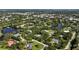 Wide angle aerial view of homes surrounded by beautiful landscaping including private lakes and lush trees at 3425 W Forest Lake Cir, Sarasota, FL 34232