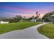 Expansive backyard with meticulous landscaping, a peaceful waterfront view, and a meandering pathway at 3425 W Forest Lake Cir, Sarasota, FL 34232