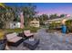 Cozy backyard patio featuring a modern fire pit, comfortable seating, and a charming gazebo at 3425 W Forest Lake Cir, Sarasota, FL 34232