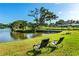 Beautiful lawn area with lounge chairs to view lake and dock; perfect for relaxing and enjoying the water at 3425 W Forest Lake Cir, Sarasota, FL 34232