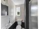 Bathroom with a shower stall, wood paneling, modern fixtures, and natural light at 3425 W Forest Lake Cir, Sarasota, FL 34232