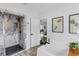 This bathroom features a black rainfall shower, marble accent wall, a spa bath, and modern finishes at 3425 W Forest Lake Cir, Sarasota, FL 34232