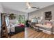 Bedroom featuring a ceiling fan, view to the backyard, and wood-look flooring at 3425 W Forest Lake Cir, Sarasota, FL 34232