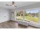 Bright bedroom with large windows overlooking the water and a comfortable sitting bench at 3425 W Forest Lake Cir, Sarasota, FL 34232