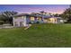 View of the home's exterior featuring a two-car garage and well-manicured lawn at 3425 W Forest Lake Cir, Sarasota, FL 34232
