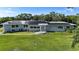 Beautiful single-story home with solar panels and lush green lawn in a serene setting at 3425 W Forest Lake Cir, Sarasota, FL 34232