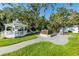 Backyard area with a hot tub and a gazebo featuring outdoor cooking facilities for relaxation and entertainment at 3425 W Forest Lake Cir, Sarasota, FL 34232