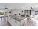Spacious kitchen with modern marble island, stainless steel appliances, and adjacent dining areas with lake views at 3425 W Forest Lake Cir, Sarasota, FL 34232