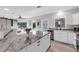 Stylish kitchen with a marble island, white cabinetry, and modern fixtures at 3425 W Forest Lake Cir, Sarasota, FL 34232