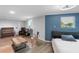 Living room featuring a bed, desk, modern decor, and blue accent wall at 3425 W Forest Lake Cir, Sarasota, FL 34232