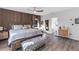 Cozy main bedroom with wood accent wall, king bed, and ensuite bathroom at 3425 W Forest Lake Cir, Sarasota, FL 34232