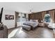 Spacious main bedroom with ensuite bathroom, king bed, and wood accent wall at 3425 W Forest Lake Cir, Sarasota, FL 34232