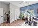 Bright home office features blue accent walls, natural light, and white closet at 3425 W Forest Lake Cir, Sarasota, FL 34232
