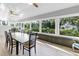 Bright sunroom with views of the backyard gardens, gazebo, and plenty of natural light at 3425 W Forest Lake Cir, Sarasota, FL 34232
