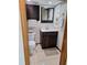 A well-lit bathroom showcases a dark-stained vanity, tiled floors, and ample storage at 3536 Countrybrook Ln # 13, Palm Harbor, FL 34684