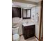 Bathroom featuring a dark wood vanity, white sink, and coordinated fixtures at 3536 Countrybrook Ln # 13, Palm Harbor, FL 34684