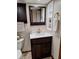 Updated bathroom featuring a new vanity, mirror, and built-in storage cabinet at 3536 Countrybrook Ln # 13, Palm Harbor, FL 34684
