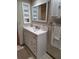 Bathroom vanity with framed mirror at 3536 Countrybrook Ln # 13, Palm Harbor, FL 34684