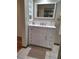 Bathroom vanity with solid surface counter and extra storage at 3536 Countrybrook Ln # 13, Palm Harbor, FL 34684