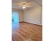 Spacious bedroom with wood-look floors and a ceiling fan at 3536 Countrybrook Ln # 13, Palm Harbor, FL 34684