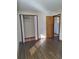 An empty bedroom features a closet and modern wood-look flooring at 3536 Countrybrook Ln # 13, Palm Harbor, FL 34684