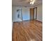 Bedroom with hardwood floors, closet, and bathroom access at 3536 Countrybrook Ln # 13, Palm Harbor, FL 34684