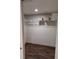 Walk-in closet with shelving and wood floors at 3536 Countrybrook Ln # 13, Palm Harbor, FL 34684