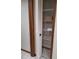 Bedroom closet with shelving behind bi-fold doors at 3536 Countrybrook Ln # 13, Palm Harbor, FL 34684