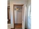 Hall coat closet with white shelving, wooden trim and bi-fold door at 3536 Countrybrook Ln # 13, Palm Harbor, FL 34684
