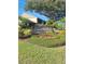 Well-maintained community sign surrounded by colorful flowers and greenery at 3536 Countrybrook Ln # 13, Palm Harbor, FL 34684